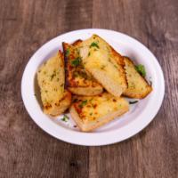 Garlic Bread · Oven baked sour dough bread. Topped with garlic, butter, Parmesan cheese and fresh parsley.