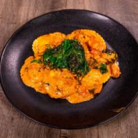 Ravioli Ripieni · Cheese stuffed ravioli with sauteed shrimp and fresh tomatoes. In prima rosa sauce. Topped w...