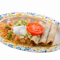 Taquitos Dorados · Taquito plate rice, beans lettuce tomato, guacamole, and sour cream.