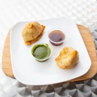 Vegetable Samosa · Wheat flour shell stuffed with spiced potatoes, onions, green peas and spices.