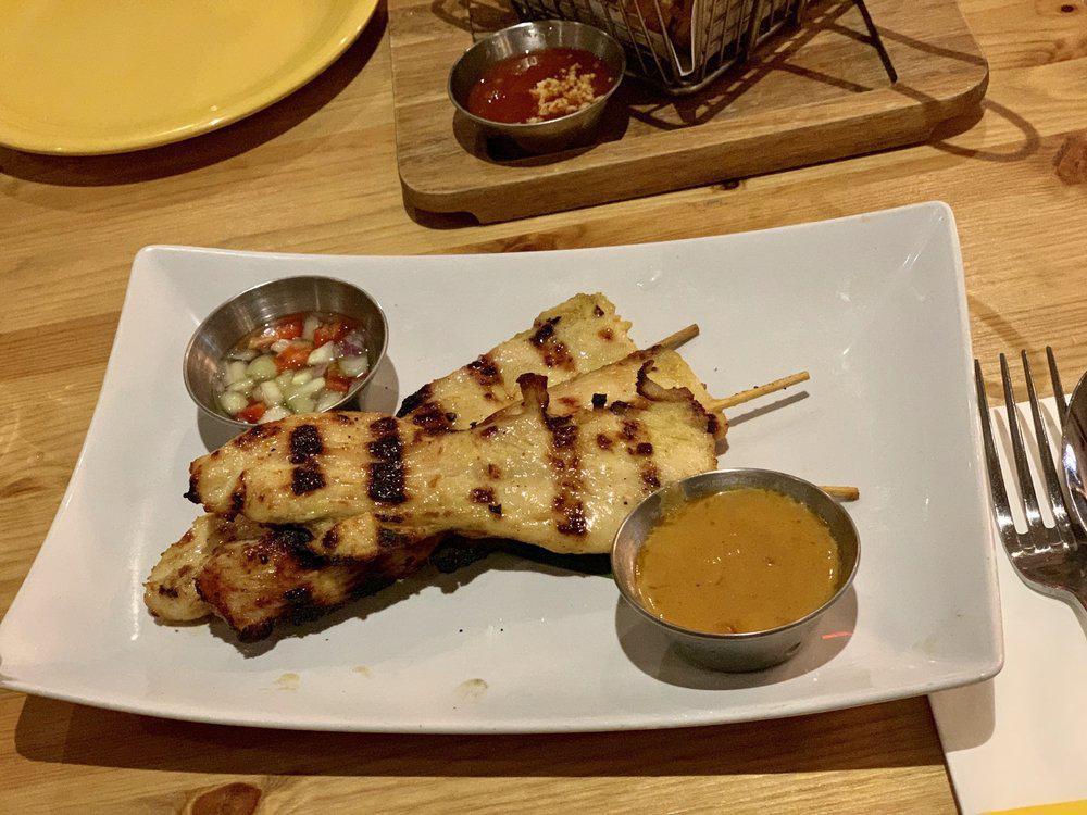 A13. Chicken Satay · Grilled marinated chicken skewers with peanut sauce and cucumber sauce.