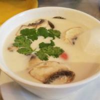 S2. Galanga Tom Kha Soup · Coconut milk based soup with mushroom, galangal, chili and lime juice. Served with your choi...