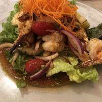 S10. Crispy Shrimp Salad · Grilled shrimp, red onion, scallion, lemongrass, lime leaves, chili paste with chili lime dr...