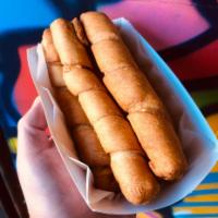 Tequenos · Cheese wrapped in dough, our take on cheesy bread.  3 Per Order.