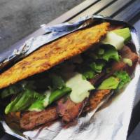 BLT Patacon · Smashed plantain sandwich stuffed with double smoked bacon, green leaf lettuce, tomatoes, an...