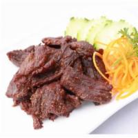 Heaven Beef · Thai style beef jerky marinated in coriander seed served with spicy Sriracha.
