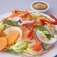 Garden Salad · Mixed green lettuce, onions, cucumber, carrots, bell peppers and tomatoes with peanut dressi...