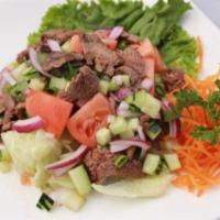 Yum Beef Salad · Grilled beef, tomatoes, cucumber, lettuce, onion and cilantro and spicy lime juice.