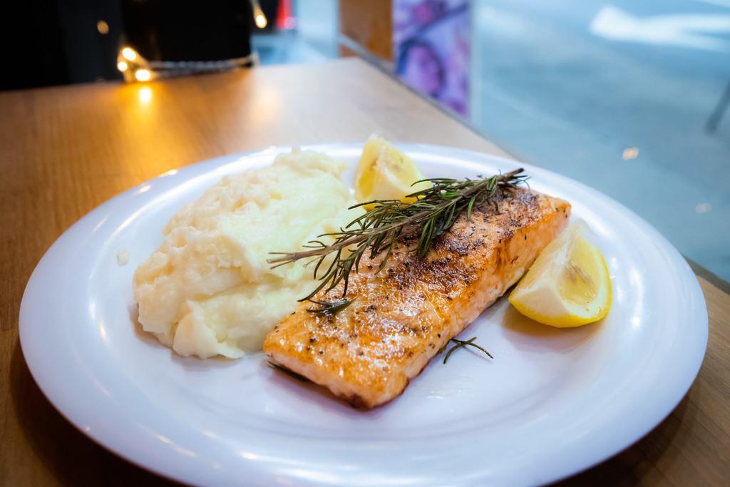Roasted salmon and 1 side · Our salmon is from the Faroe Islands is renowned for its superior quality and taste. 
We roasted with olive oil, paprika, salt, pepper with a piece of rosemary on top for more flavor. 