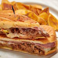Cubano Sandwich · Served with classic pressed Cuban sandwich of roasted pork, ham, Swiss cheese, pickles and m...