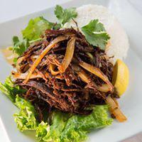 Vaca Frita · Served with pan seared shredded skirt steak, fresh mojo, onions and lime.