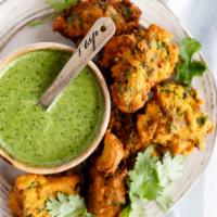 Vegetable Pakora · Crispy fritters of carrots, potatoes, onions, cauliflower and cottage cheese.