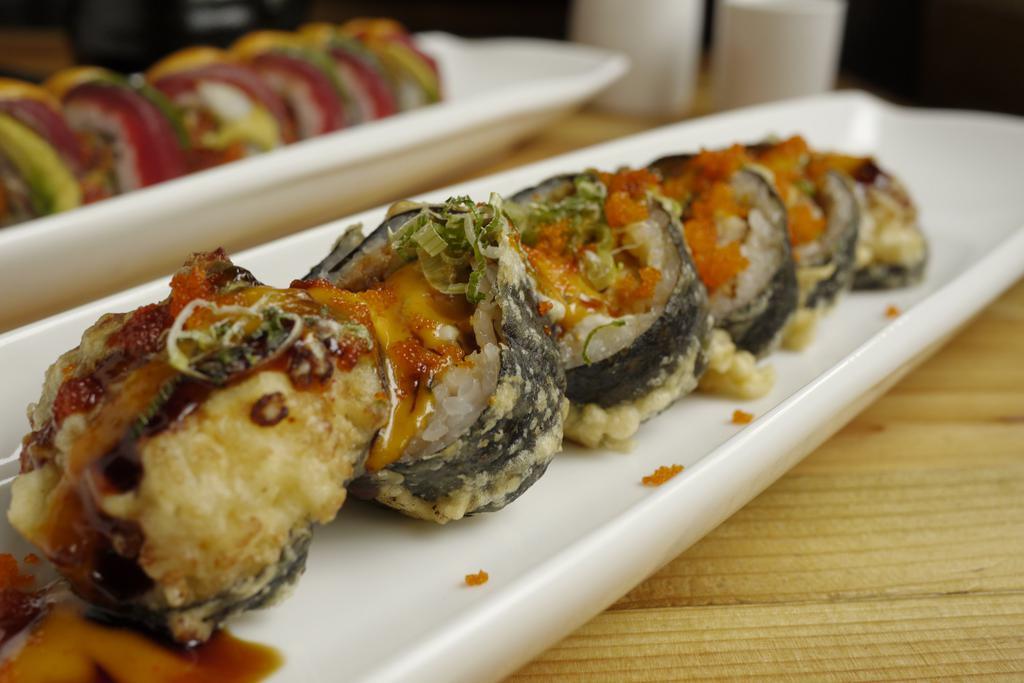 Godzilla Roll · Spicy tuna, avocado and cream cheese inside, deep fried on top with eel sauce and spicy mayonnaise.