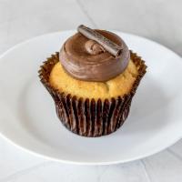 Vanilla and Chocolate Cupcake · Vanilla cake frosted with chocolate buttercream topped with chocolate shavings.