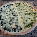 White Pizza with Spinach · A sauceless pie topped with ricotta, mozzarella, and Parmesan cheese.