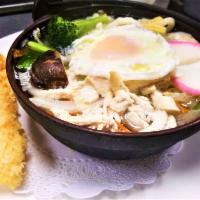 Nabeyaki Udon · A big bowl of udon noodle soup with chicken, egg, fishcakes, vegetables and 1 piece of shrim...