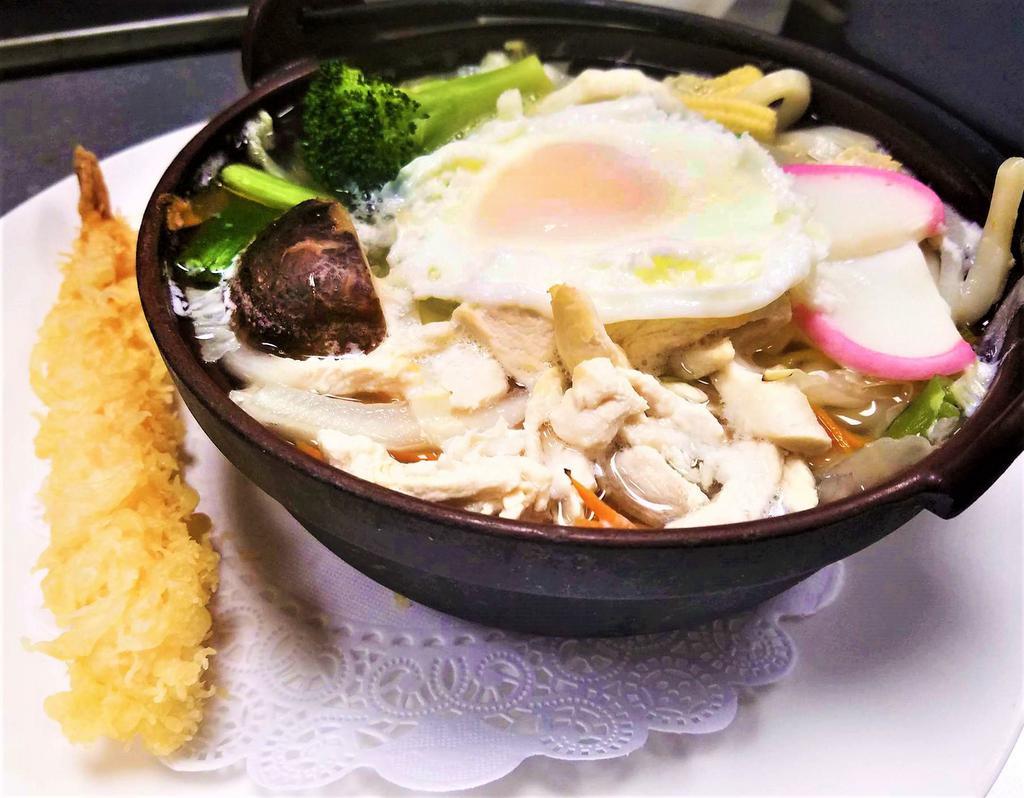 Nabeyaki Udon · A big bowl of udon noodle soup with chicken, egg, fishcakes, vegetables and 1 piece of shrimp tempura.