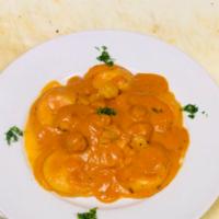 Lobster ravioli · Served in a pink sauce with shrimp