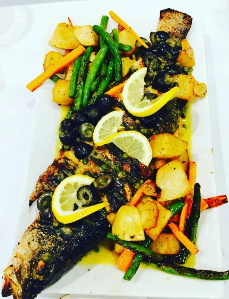 Grilled Bronzini · Served with risotto and sauteed vegetables.