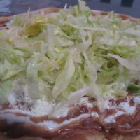 Huarache Regular · Home made tortilla topped with beans, sour cream, cheese and lettuce.