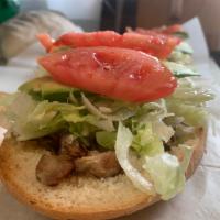 Torta de carnitas  · Pork Mexican sandwich with avocado, onion, beans, tomato, and mayonnaise.