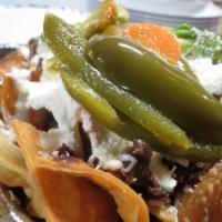 Nachos · Tortilla chips topped with beans, meat (vegetarian option) sour cream, string cheese (quesio...