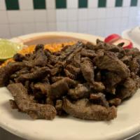 Carne Asada · Grilled steak sereved with rice, beans, and tortillas on the side.