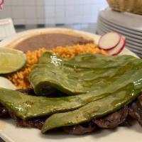 Cecina con Nopales · Salted beef with grilled cactus. It is served with rice, beans, and tortillas on the side.