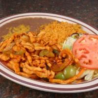 Pollo Ranchero · Chicken in a red spicy sauce, served with rice, beans, salad and tortillas.