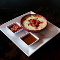 Choriqueso Fundido · Spicy chorizo mixed in melted cheese, served with a side of tortillas and salsa.