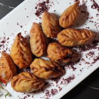 Gurza · 4 pieces. A variation of dumplings consisting of a ground lamb filling wrapped in 1mm thin d...