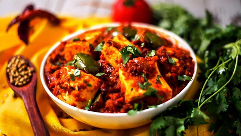 14. Kadai Paneer · Cheese cooked with bell peppers, onions, and tomatoes.