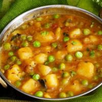 17. Aloe Matar · Potatoes, green peas with onions, and tomato sauce. Vegan.