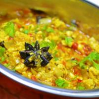 19. Paneer Bhurji · Grated cheese sauteed in onion, tomatoes, and bell peppers.