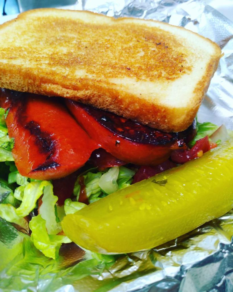 Vegas Hot Link Sandwich · 100% beef link, lettuce, tomato and BBQ sauce on potato bread.