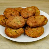 Alu Tikki · 2 pieces. Homemade patty of potatoes and peas with a touch of ginger.