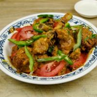 Chicken Karahi · Pieces of chicken, cooked with fresh tomatoes, green chilies, fresh ginger, and spices.