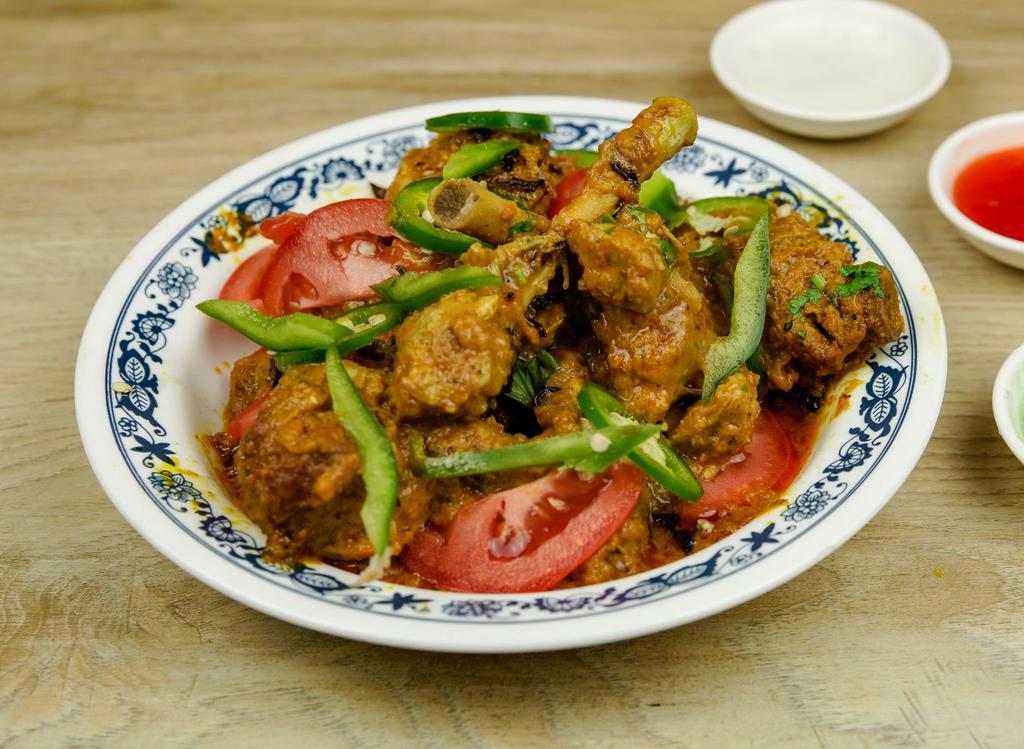 Chicken Karahi · Pieces of chicken, cooked with fresh tomatoes, green chilies, fresh ginger, and spices.