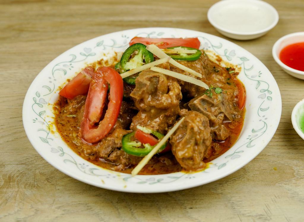 Goat Karahi · Goat cooked with fresh tomatoes fresh ginger, fresh green peppers, herbs, and spices.