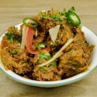 Goat Curry · Goat meat cooked in tomatoes, herbs, and spices.