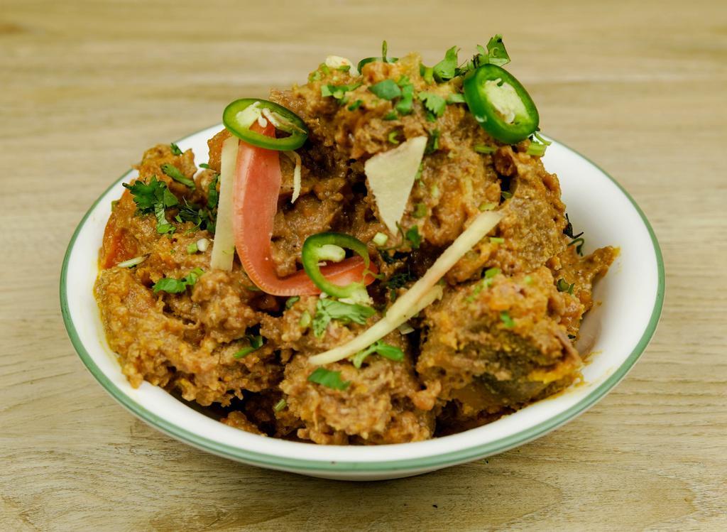 Goat Curry · Goat meat cooked in tomatoes, herbs, and spices.