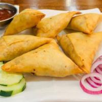 2. Vegetables Samosa · A fried pastry with a savory potato filling.