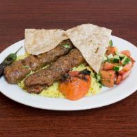 Large Adana Kebab · Ground lamb flavored with red bell peppers slightly seasoned with paprika and grilled on ske...