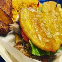 Jibarito Lechon · Fried plantain sandwich with lechon (slow roasted pork) includes mayo, lettuce, tomato, garl...