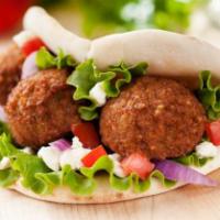 fresh Falafel over salad · It comes with Mix green cucumbers tomatoes olives and hummus