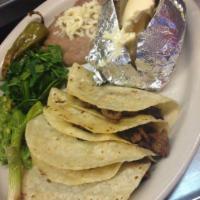 Steak Tacos · 4 soft corn tacos served with baked potato beans and guacamole.