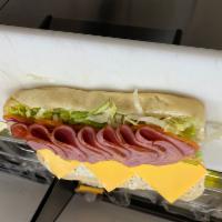 Turkey Ham Sub · Comes with mayonnaise, lettuce, tomatos, onions, banana peppers, Italian dressing, and chees...