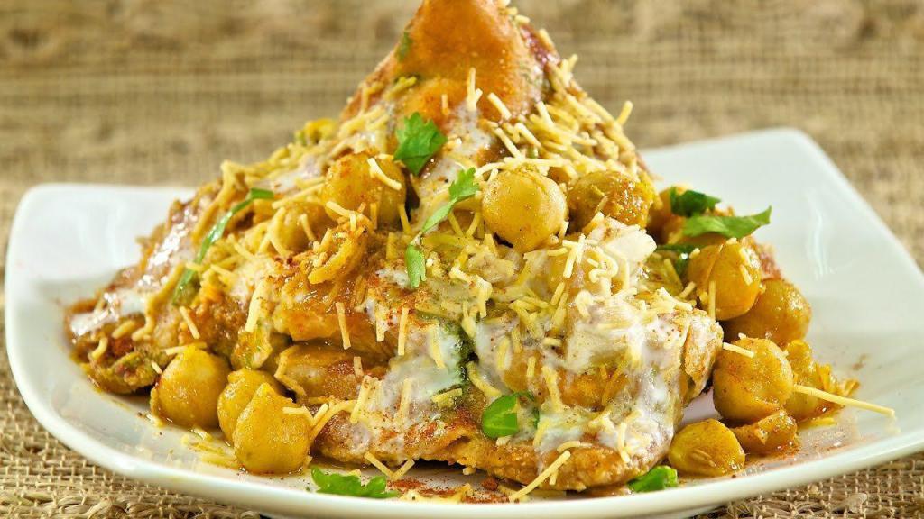 Samosa Chaat · Samosa served with chickpeas, sweet and mint chutney spices.