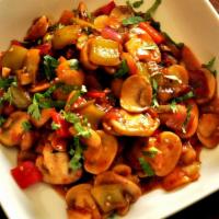 Chilly Mushroom · Sliced Mushroom sauteed with bell pepper, onions & chilly sauce.