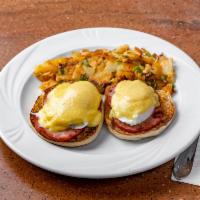 Eggs Benedict · Poached eggs with Canadian bacon on an English muffin topped with Hollandaise sauce. Served ...